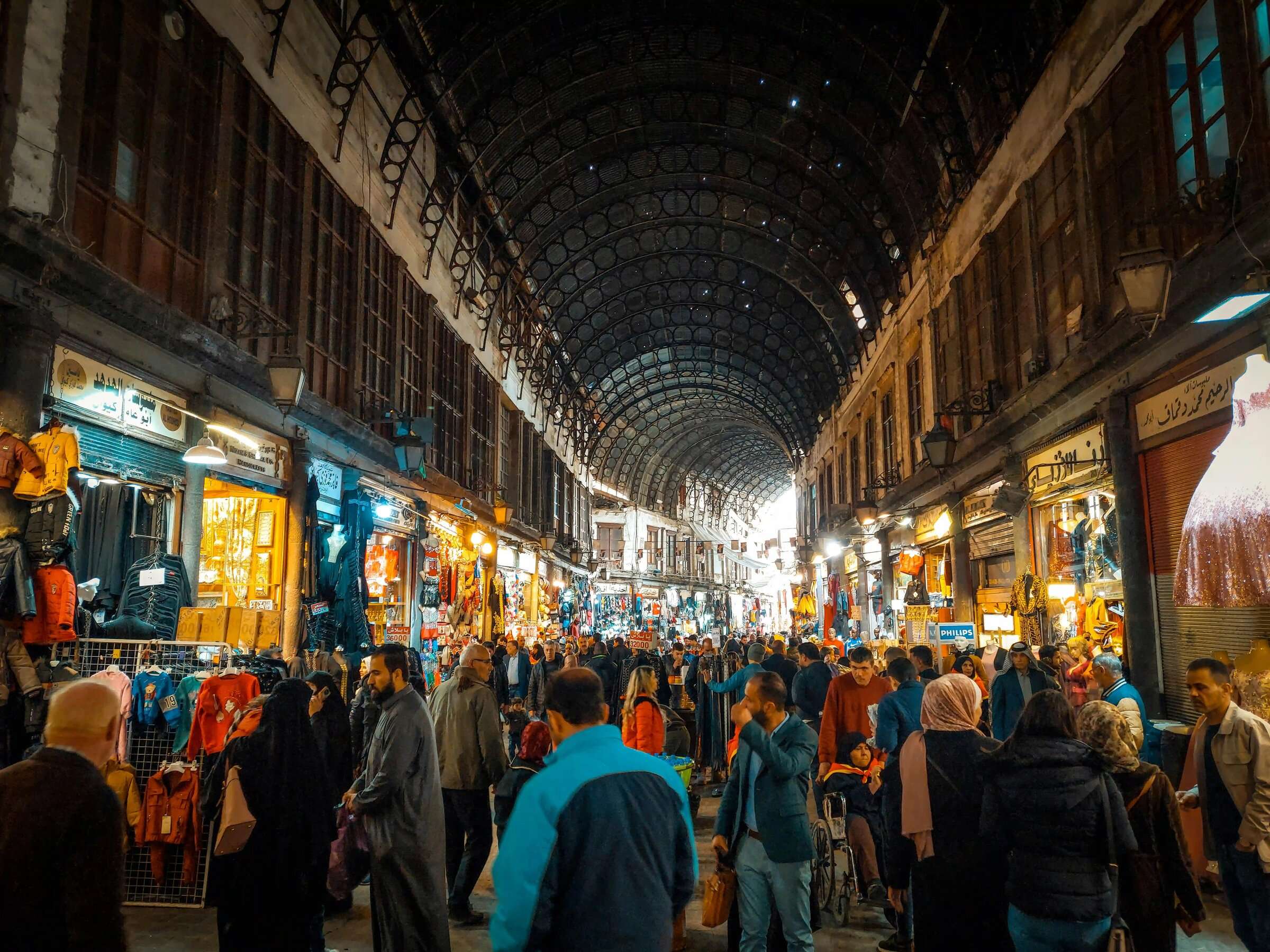 Crowds beneath the vaulted iron roof of Al-Hamidiyah Souq in Damascus
